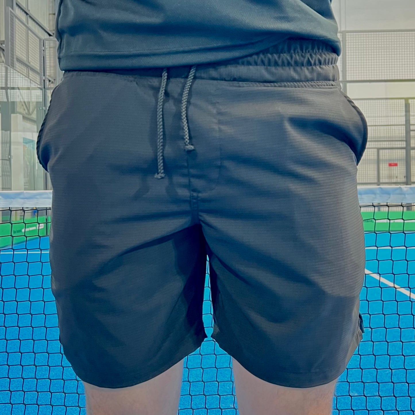 Person wearing dark shorts on a sports court