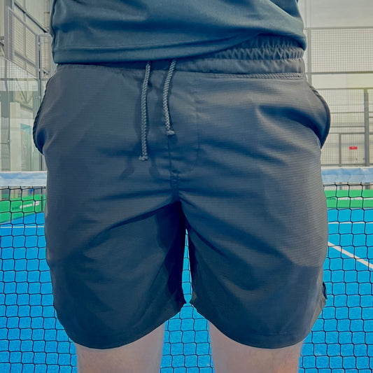 Person wearing dark shorts on a sports court
